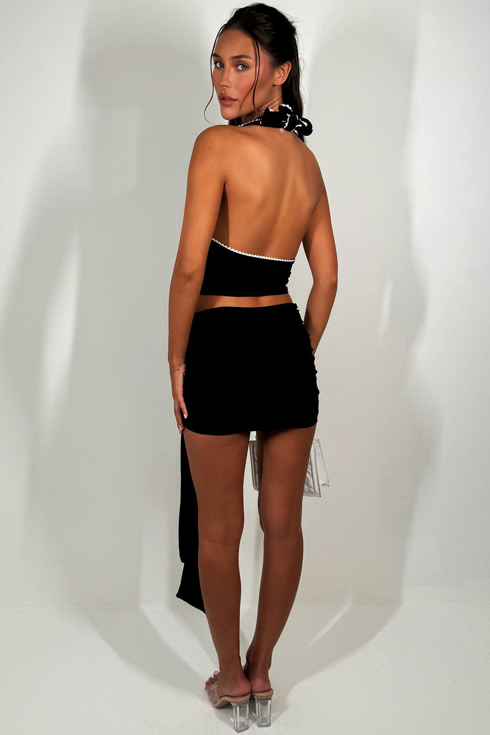 black backless halterneck crop top and mini drape skirt co ord set