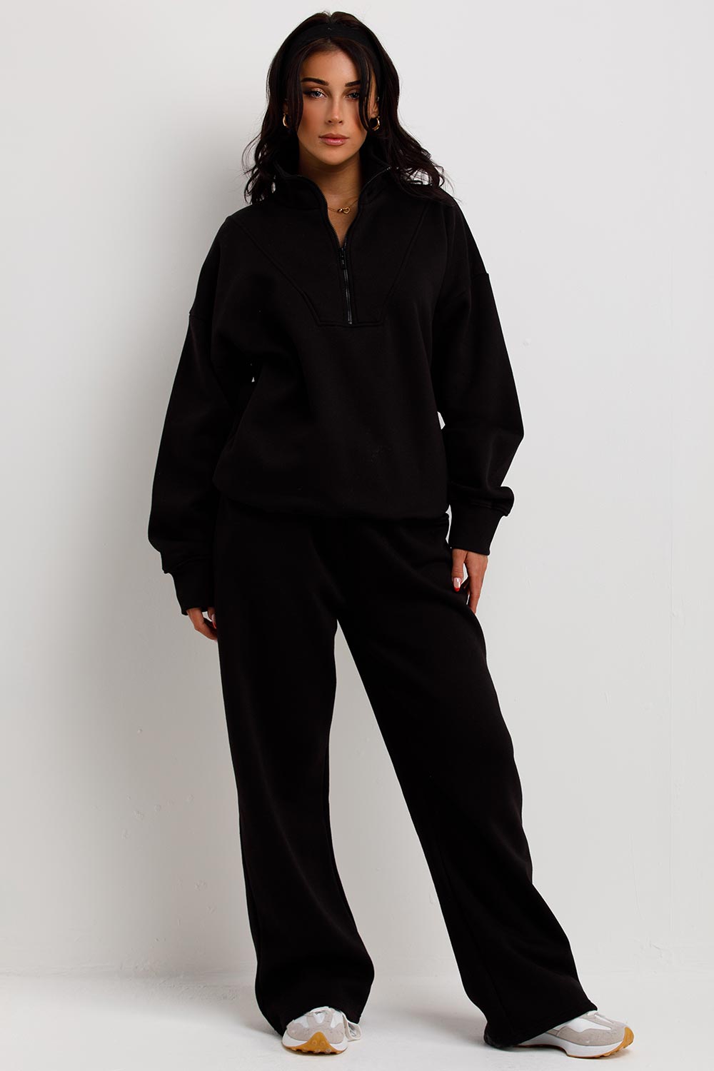 womens loungewear co ord black wide leg joggers and half zip sweatshirt airport outfit