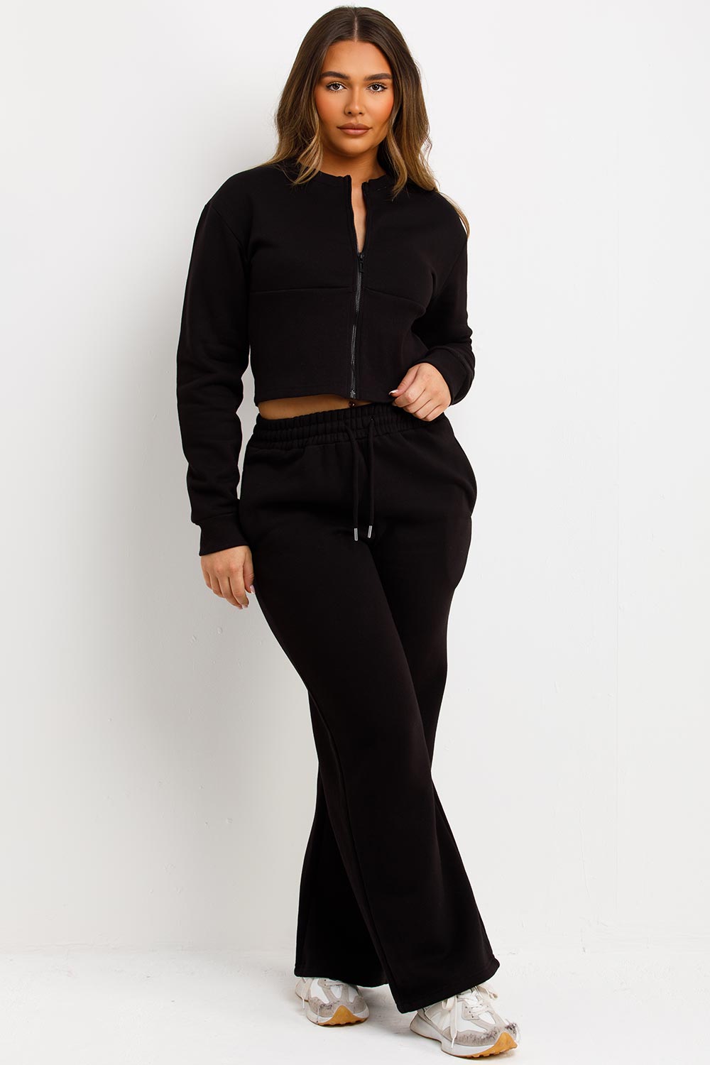 black zip up corset crop sweatshirt and joggers tracksuit travelling airport outfit styledup