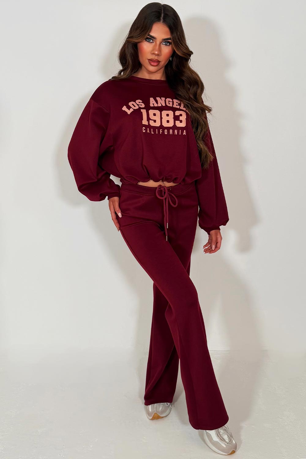 womens oversized crop sweatshirt and bell bottom flare trouser two piece loungewear co ord set burgundy with los angeles california slogan styledup
