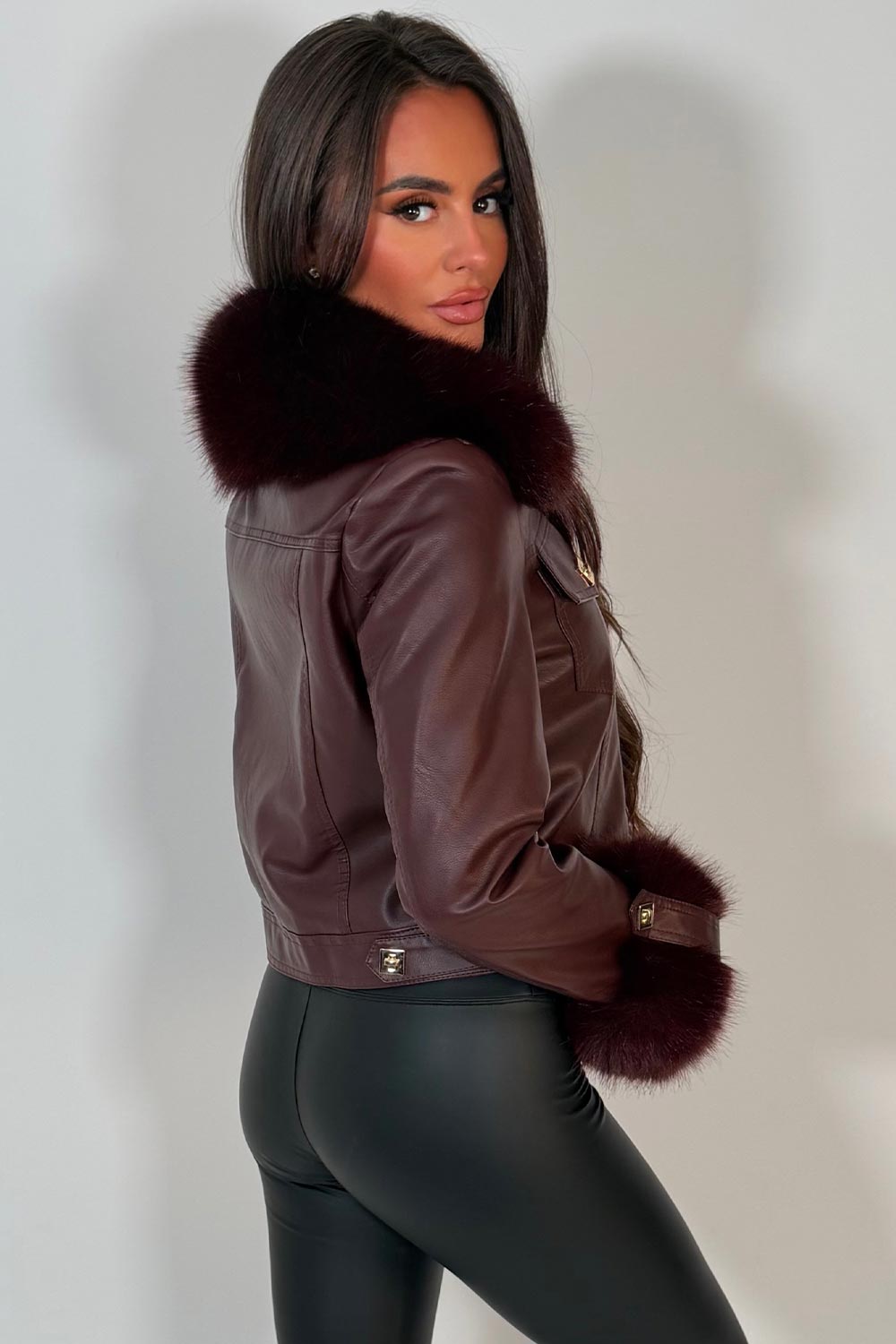 womens fur cuff and collar faux leather jacket with gold buttons styled up uk christmas party outfit