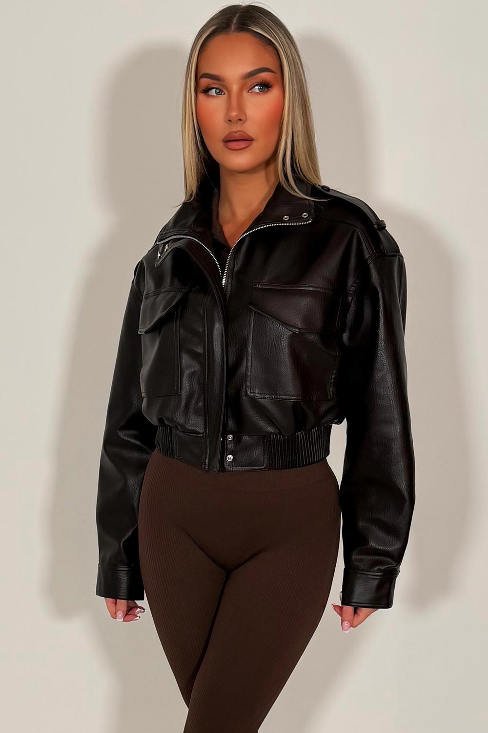 womens brown faux leather jacket with shoulder tabs long cuffed sleeves front pockets with flaps elasticated hem zip up front hidden by a placket with snap buttons zara uk styledup