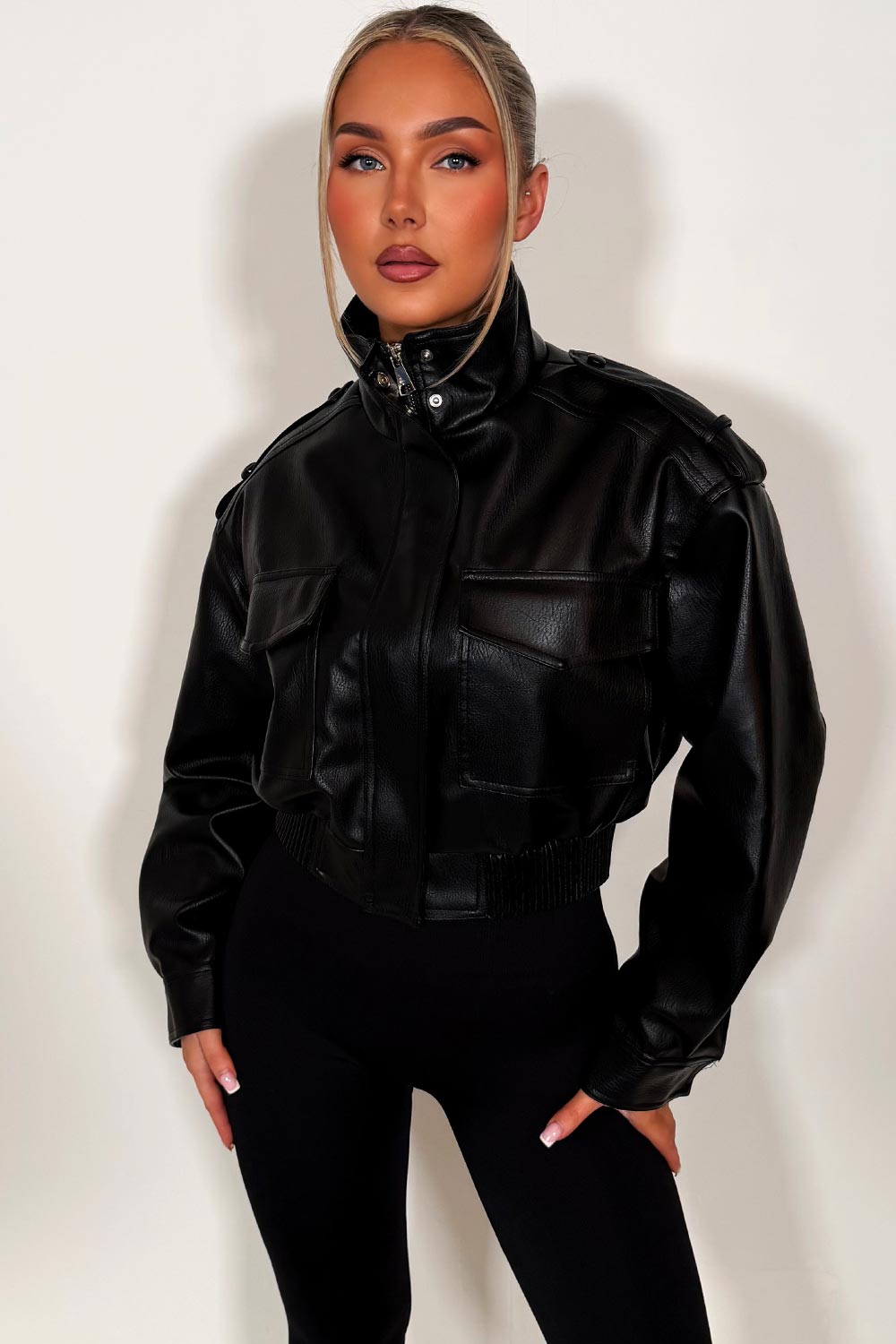 black faux leather jacket with high collar long sleeves shoulder tabs pockets on front zip fastening styledup zara womens