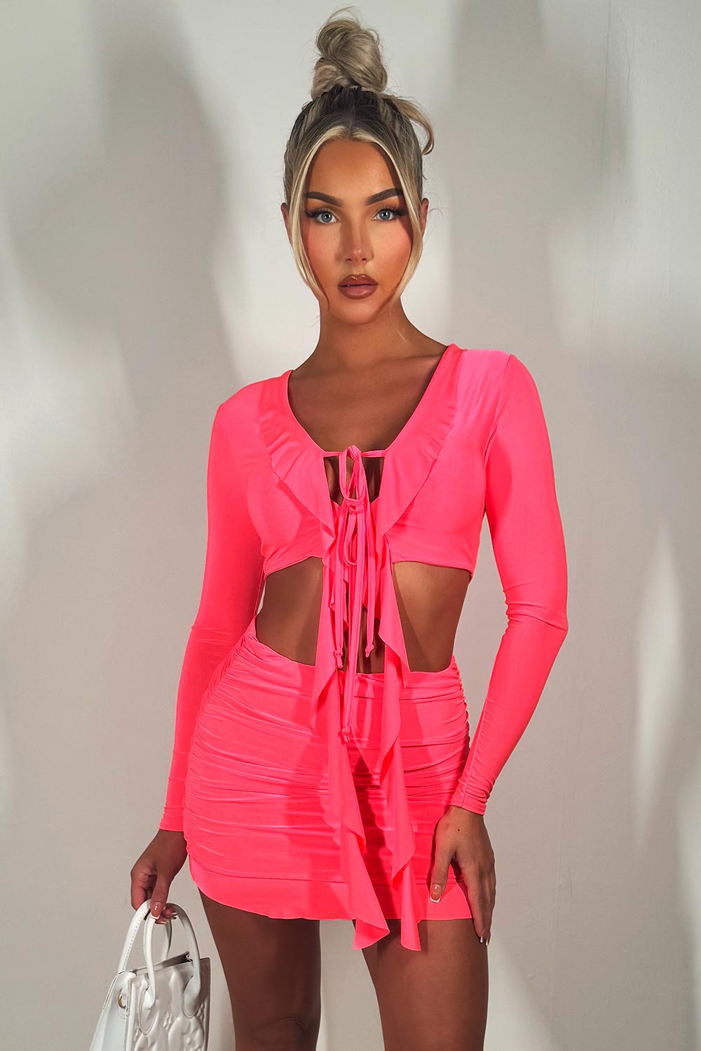 neon pink festival mini frill hem skirt and long sleeve tie front crop top set going out holiday outfit