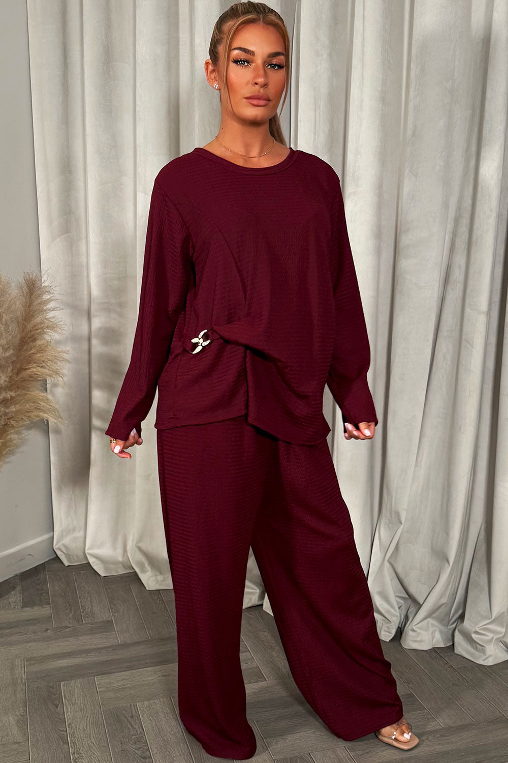 womens black long sleeve top and trousers co ord set with gold buckle