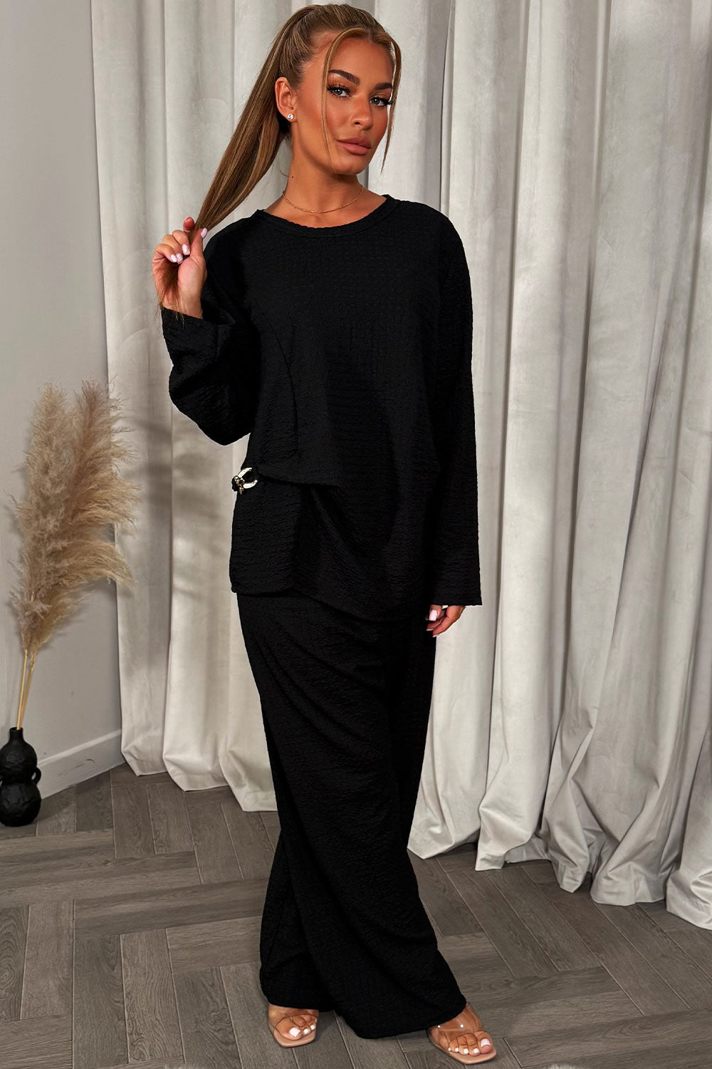 womens black long sleeve top and trousers co ord set with gold buckle