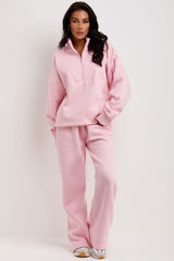 pink jumper and joggers tracksuit set airport outfit