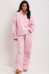 pink half zip sweatshirt and straight leg joggers tracksuit airport outfit