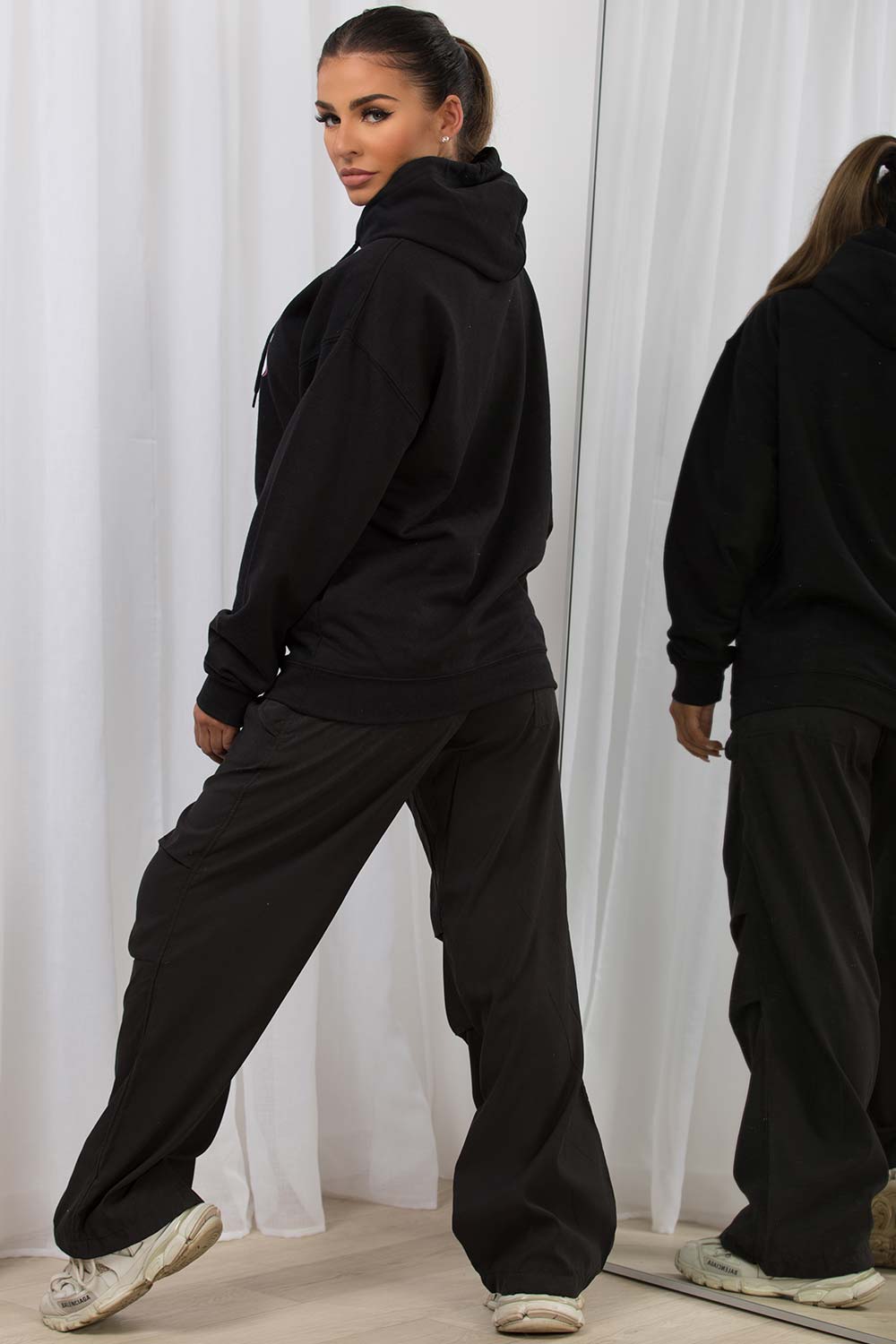 womens black oversized hoodie with all you need is love slogan