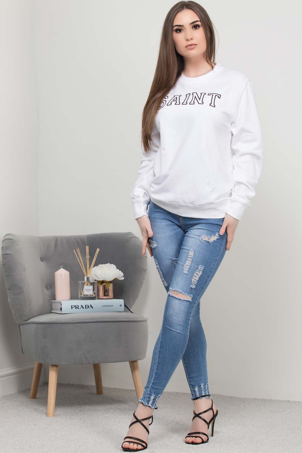 white sweatshirt with saint slogan