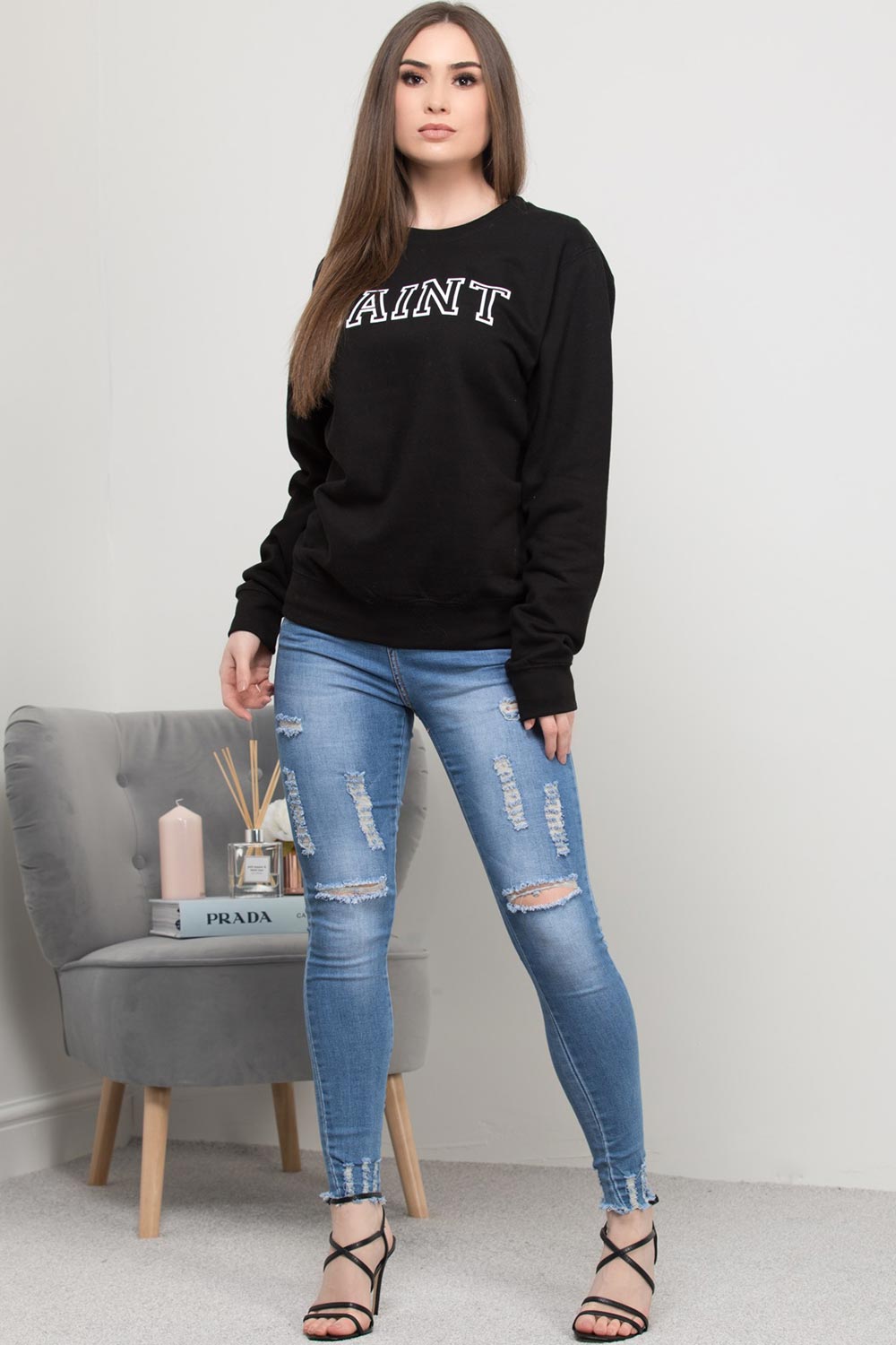 black sweatshirt with saint slogan