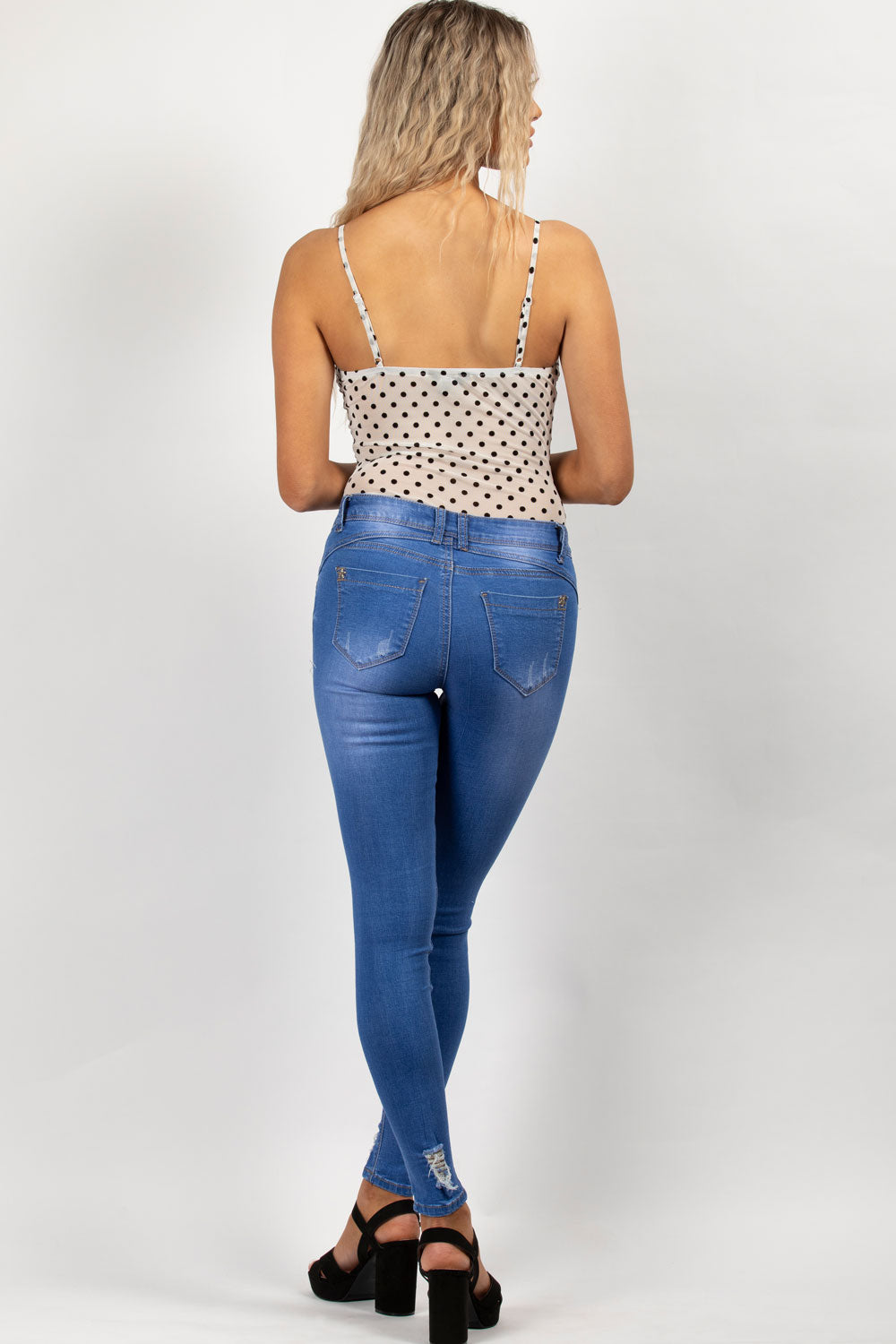 mid wash blue distressed skinny jeans