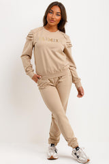 womens tracksuit with gold button and ruffle frill shoulders baimily paris slogan