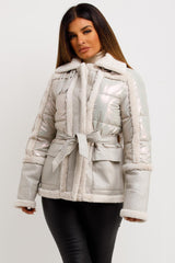 womens shiny padded jacket with faux fur trim and suede pockets with belt