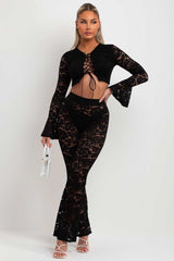 black lace skinny flare trousers and bell sleeve lace up front going out crop top summer holiday festival rave outfit