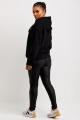 womens oversized black hooded sweatshirt with the lovely club slogan