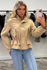 womens beige funnel neck jacket with gold buttons and adjustable drawstring cinched waist 