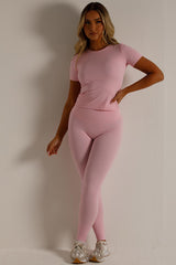 skims womens sports short sleeve top and leggings two piece set