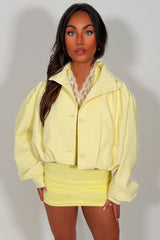 womens yellow bomber jacket with funnel nect long sleeves button fastening styledup uk