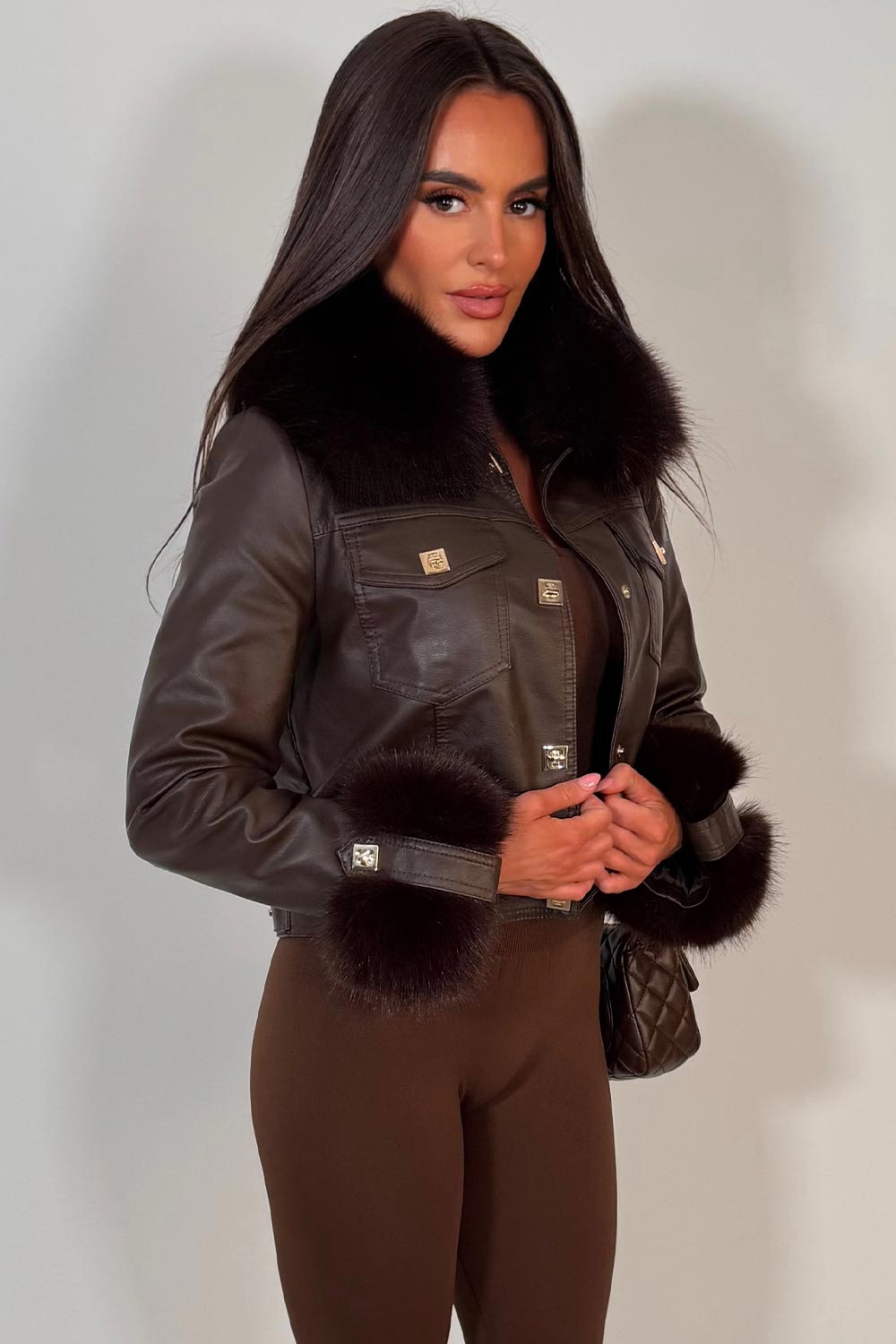 womens fur cuff and collar brown faux leather jacket with gold buttons styled up uk christmas party outfit 