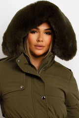 womens long padded puffer coat with fur hood and waist belt