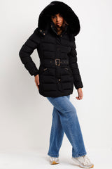 womens puffer padded quilted coat with fur hood and belt styled up