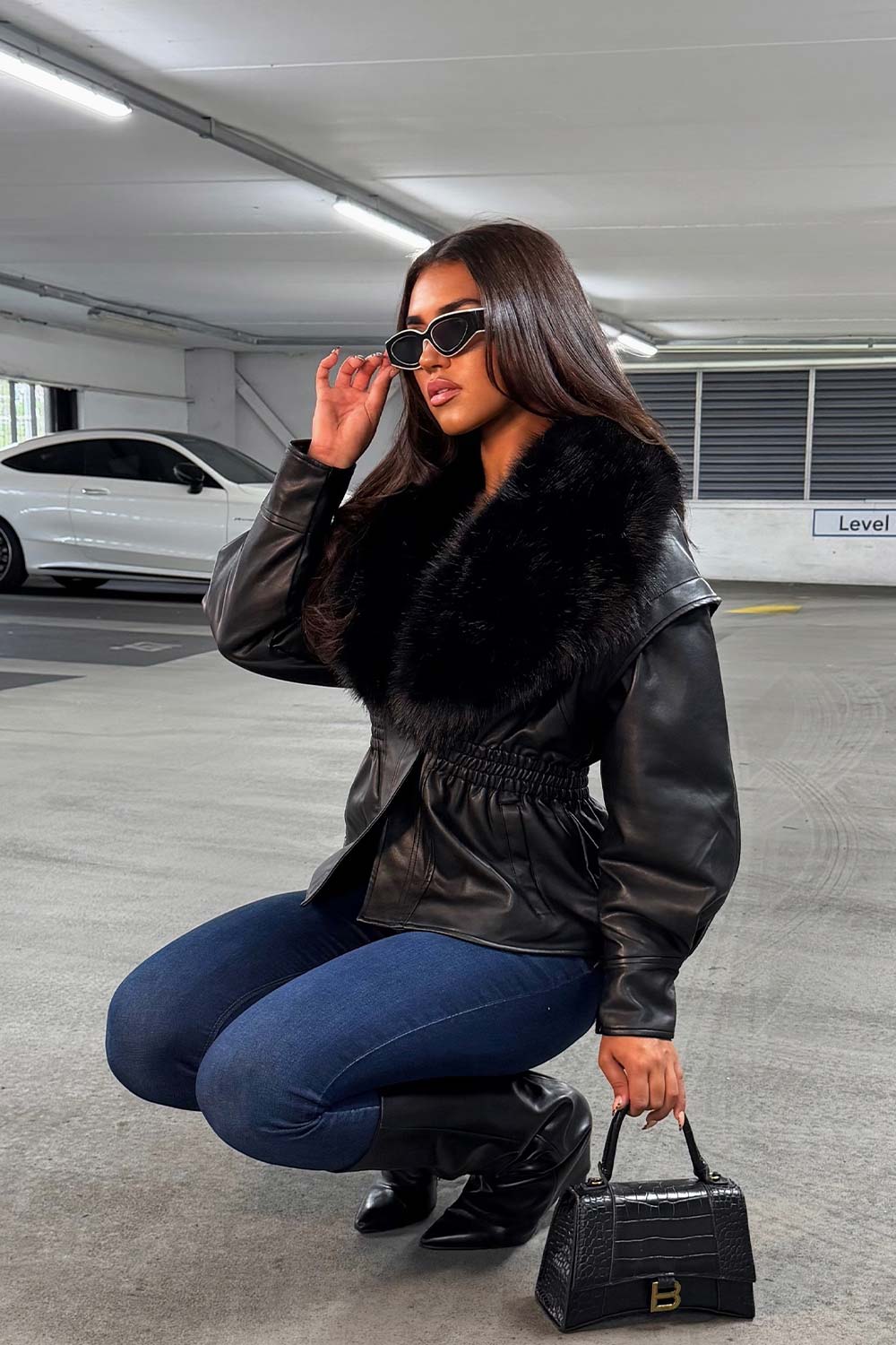 womens winter jacket with faux fur collar in faux leather cinched waistline styledup uk