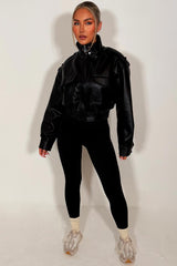 womens black faux leather short jacket with high collar long sleeves shoulder tabs pockets on front zip fastening zara uk styledup 