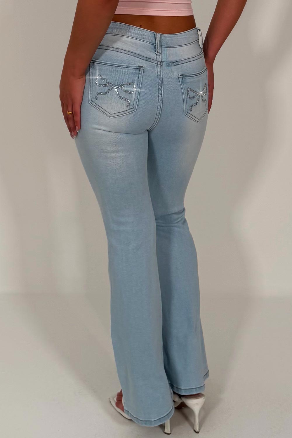 womens zara ripped knee flare leg boot cut jeans with diamante rhinestone bow detail styledup fashion