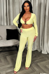 yellow flare trousers and long sleeve crop top with gold buckle two piece set weekend outfit womens