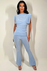 sky blue skinny flare trousers with fold over detail and occasion top with shoulder pads two piece set going out occasion outfit