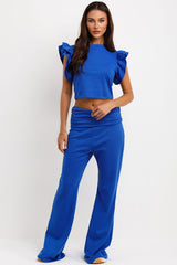 skinny flare fold detail trousers and ruffle frill sleeve top two piece co ord set airport outfit