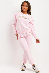 womens tracksuit with gold button and ruffle frill shoulders baimily paris slogan