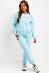 gold button frill shoulder top and trousers loungewear set womens summer airport outfit