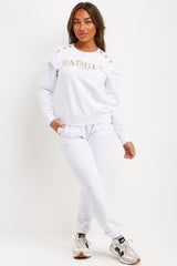 womens tracksuit with gold button and ruffle frill shoulders baimily paris slogan