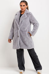 belted fur coat with collar and button fastening 