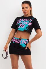 mini skirt and crop t shirt co ord with no one is innocent slogan