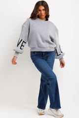 grey jumper with knitted sleeves love slogan styledup