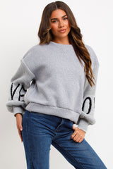 womens winter jumper sweatshirt with knitted sleeves love slogan styled up