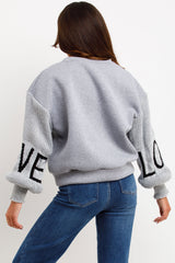 womens knitted sleeve jumper with love slogan