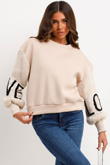 womens winter jumper sweatshirt with knitted sleeves love slogan styled up