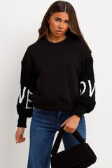 womens winter jumper sweatshirt with knitted sleeves love slogan styled up