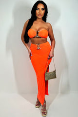 neon orange bandeau top and side cut maxi skirt with gold buckle set going out holiday festival outfit