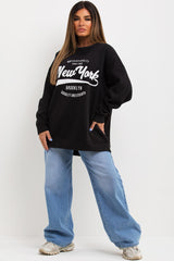 womens black oversized sweatshirt with new york slogan