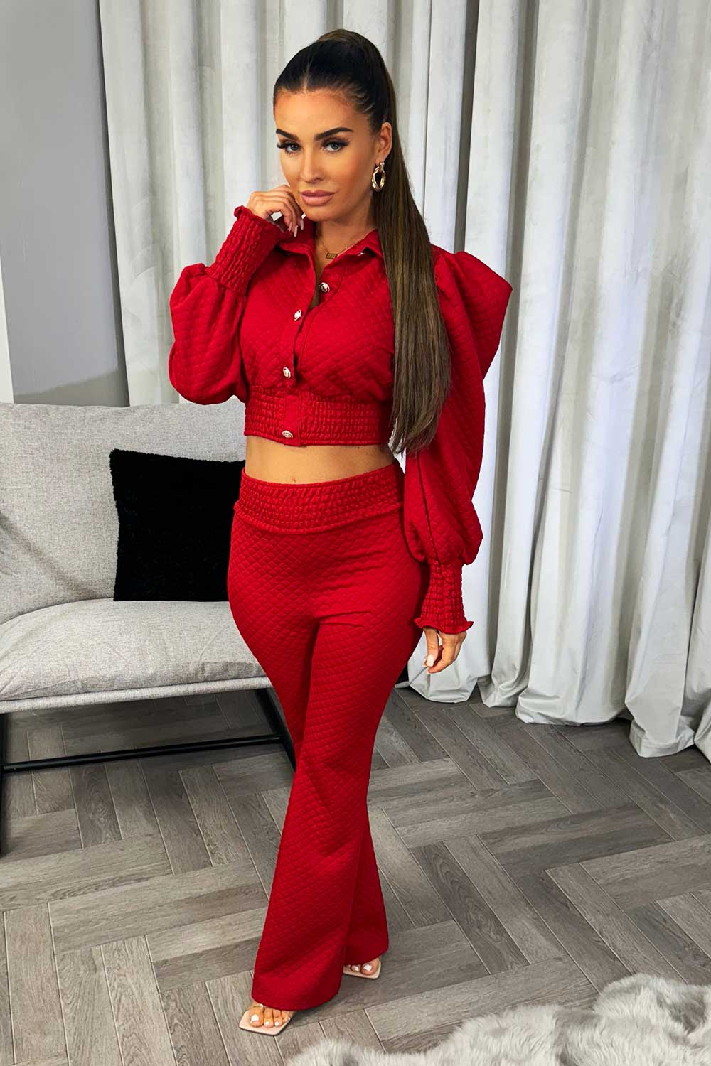 red quilted puff sleeve top with gold buttons and flared trousers co ord set going out christmas party outfit
