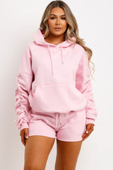 womens pink short tracksuit oversized ruched sleeve hoodie and shorts lounge set airport outfit