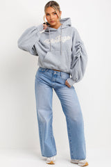 womens ruched sleeve hoodie with vintage slogan