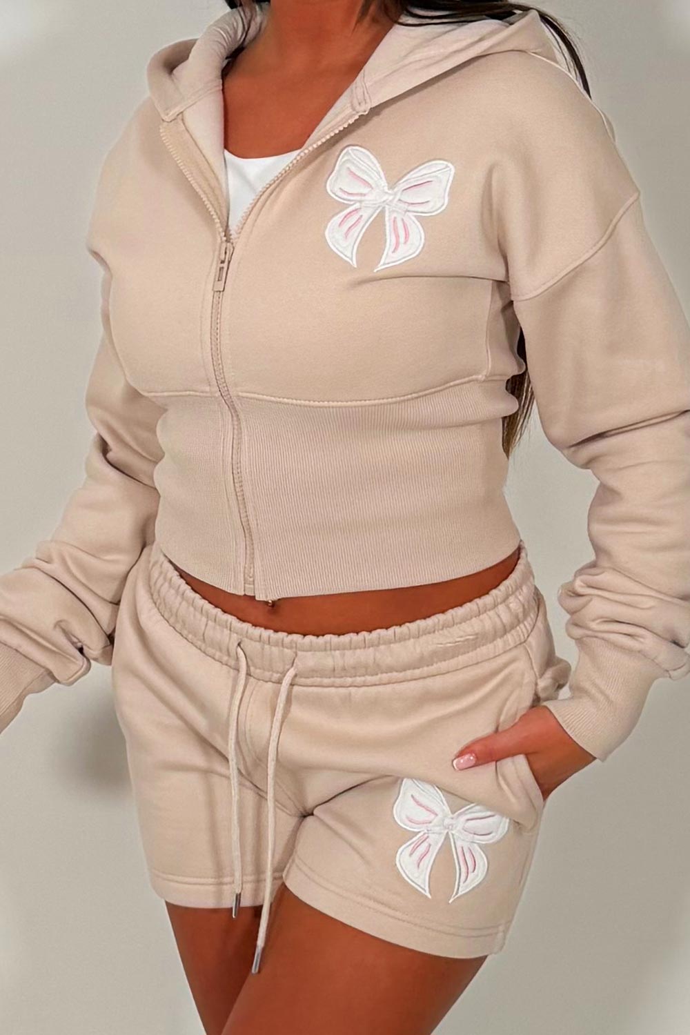 womens cinched waist crop corset hoodie and shorts tracksuit bow detail airport outfit co ord 