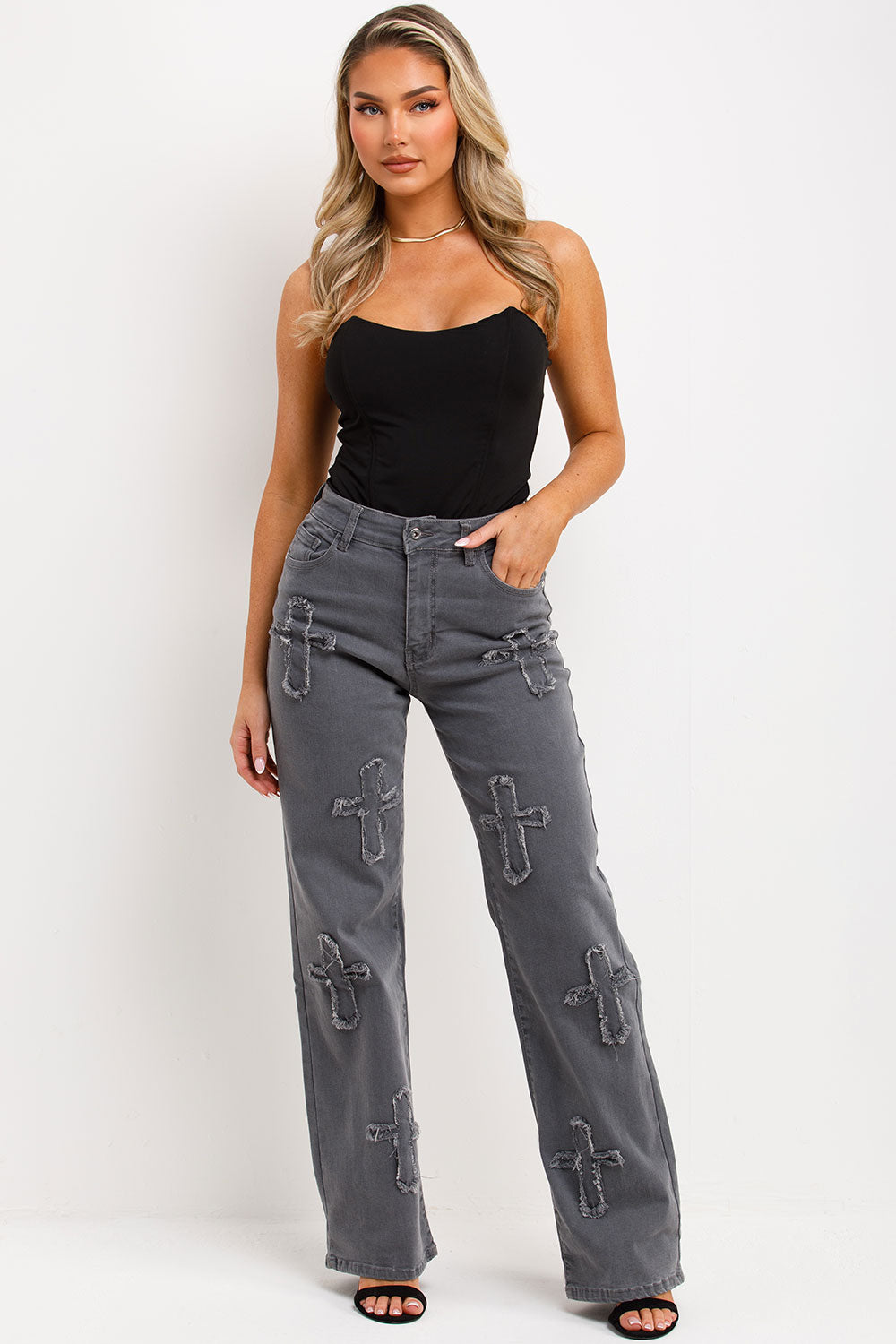 womens wide leg denim jeans with cross applique styled up 