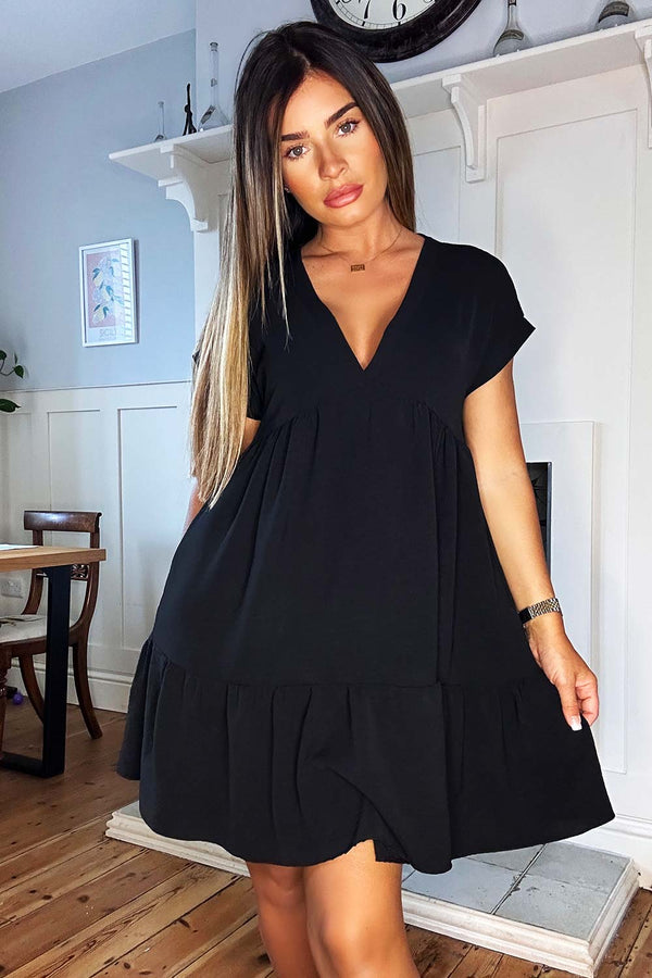 black smock dress Womens Smocked in Midnight L (12-14) The high neck with its elegant tie detail adds a sophisticated touch tiered-black-smock-summer-dress-styledup-fashion_600x.jpg?v=1686163500